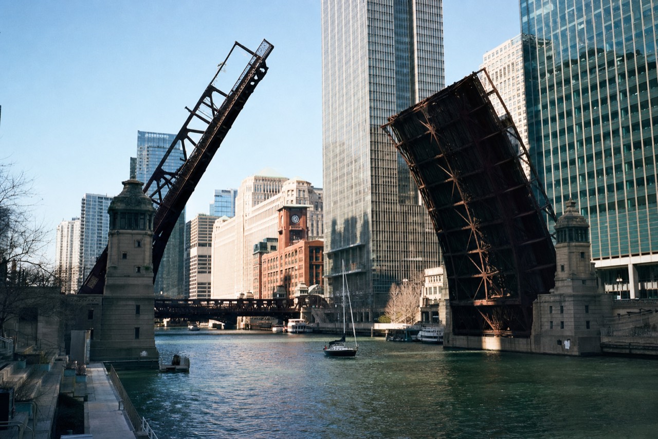 A Chicago bascule bridge raised over the river with downtown towers behind it, no text, no logos, no people.