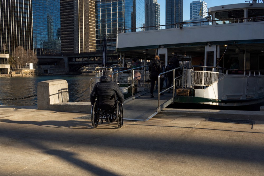 Tour boats moored along the Chicago Riverwalk near downtown bridges, no text, no logos, no people.